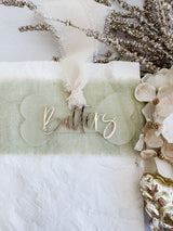 Frosted dog bone shaped bauble with cursive mirror name