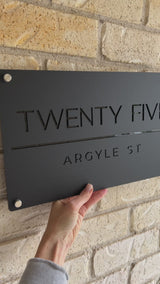 Matte black house address sign with stand-off mounts