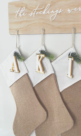 Natural burlap Christmas stocking with initial tag
