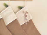 Natural burlap Christmas stocking with frosted name tag