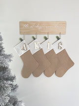 Natural burlap Christmas stocking with initial tag